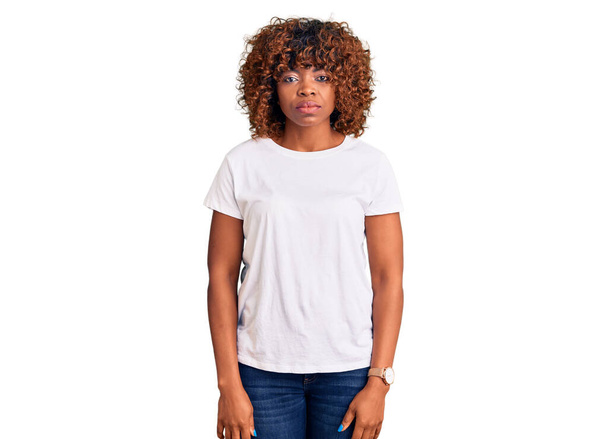 Young african american woman wearing casual white tshirt depressed and worry for distress, crying angry and afraid. sad expression.  - 写真・画像