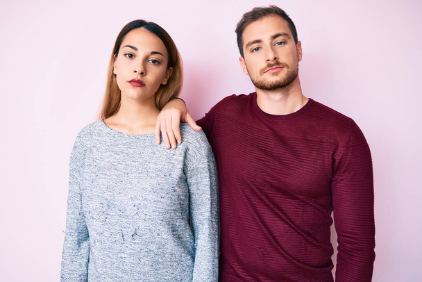 Beautiful couple wearing casual clothes relaxed with serious expression on face. simple and natural looking at the camera.  - Fotoğraf, Görsel