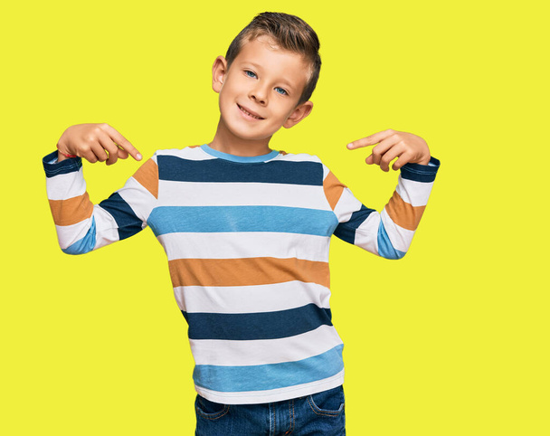 Adorable caucasian kid wearing casual clothes looking confident with smile on face, pointing oneself with fingers proud and happy.  - Fotografie, Obrázek