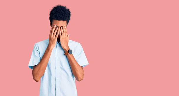 Young african american man wearing casual clothes rubbing eyes for fatigue and headache, sleepy and tired expression. vision problem  - Photo, Image