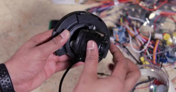 Un tecnico che ripara telecamere a circuito chiuso nel centro servizi - Filmati, video