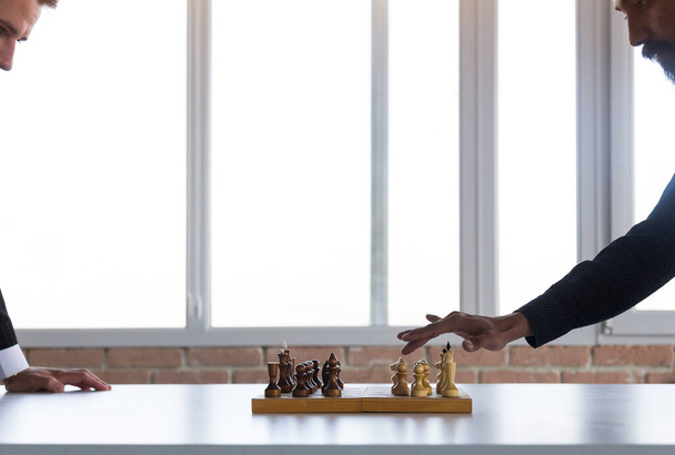 two male businessmen, rivals are playing chess. Strategy and rivalry. - Foto, Imagem