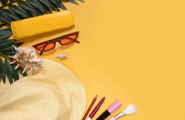 Travel travel accessories, womens accessories, lipstick, mascara, pencil, glasses, hat on a bright yellow background with blank space for text. Travel or vacation concept top view. Summer background. - Φωτογραφία, εικόνα
