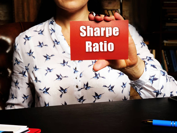 Blank red business card with inscription Sharpe Ratio in person hand. Horizontal shot. Close-u - Photo, Image