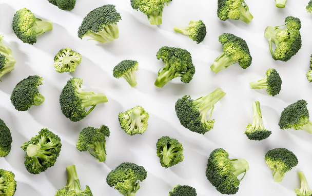 Green broccoli pattern food. Isolated vegetable on white background. Top view. - Foto, Imagem