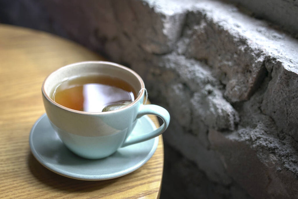 Cup of hot tea on a wood table next to windows, - Foto, immagini