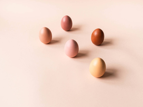 Trend monochrome pastel colorful Easter eggs on beige background. Front view. Copy space - Photo, Image