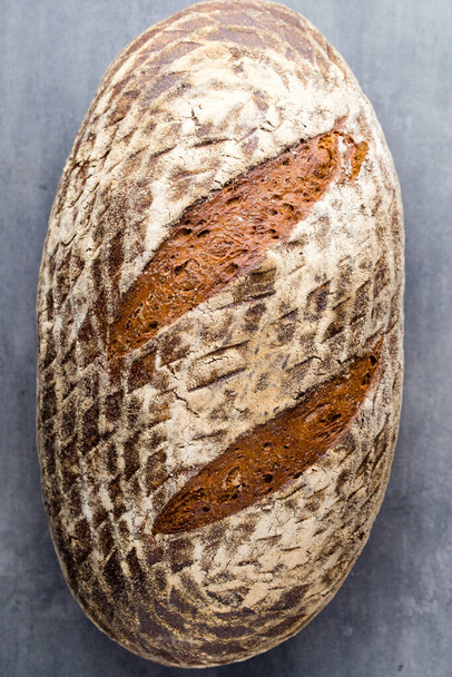 Rye fresh bread on he gray background. - Foto, afbeelding
