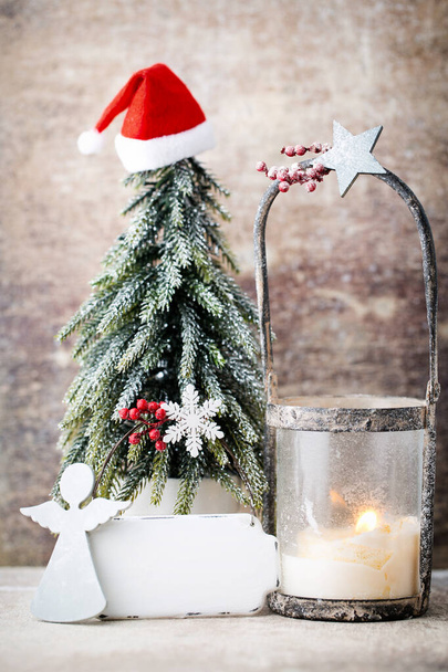 Christmas card with lantern candle and fir cones on old wooden background. - Фото, зображення