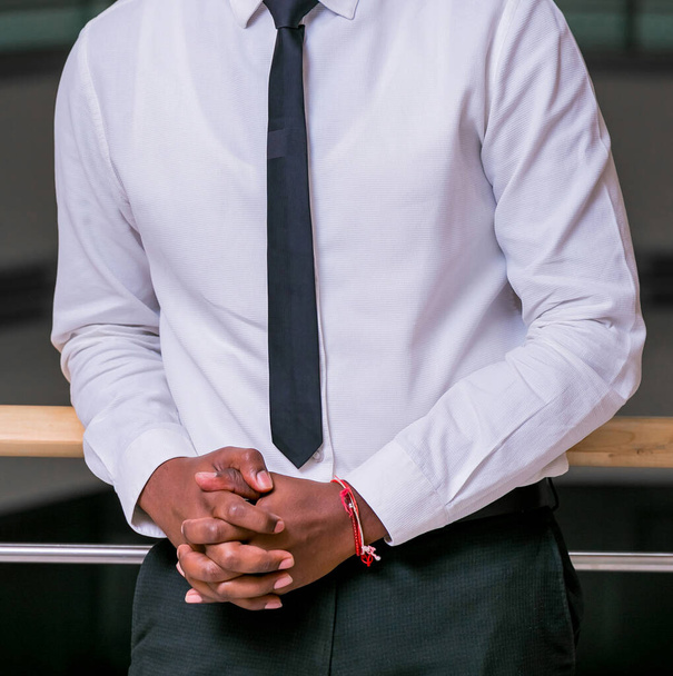 An African-American businessman posing near the railing in the office - Photo, Image