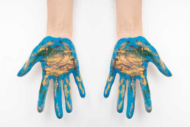 A top view of hands painted like the earth isolated on a white background - Foto, Imagem
