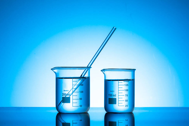 The two glass flasks with liquid on a lab tab - Zdjęcie, obraz