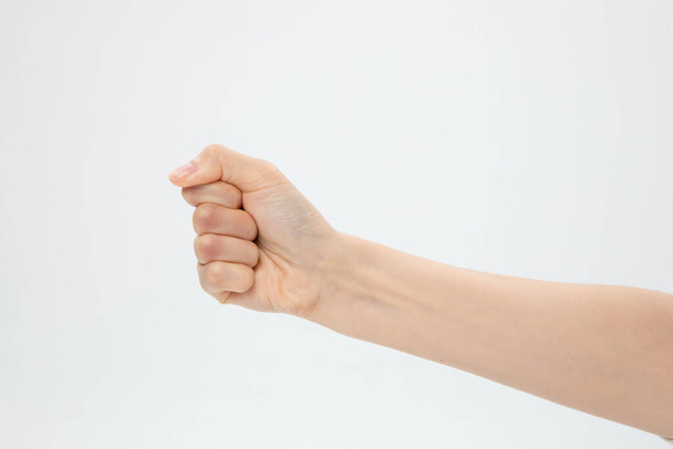 A closeup shot of a hand in a fist isolated on a white background - Photo, Image