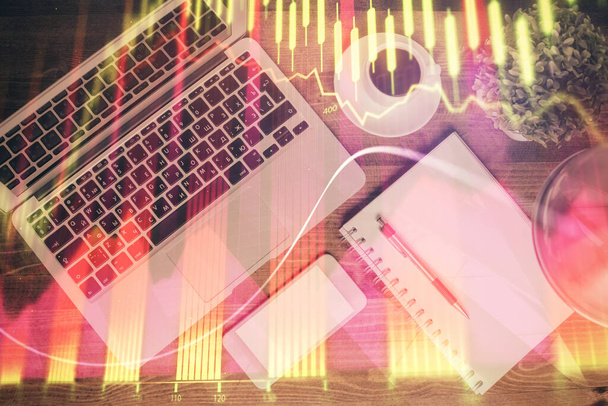 Financial market graph and top view computer on the desktop background. Double exposure. Investment concept. - 写真・画像