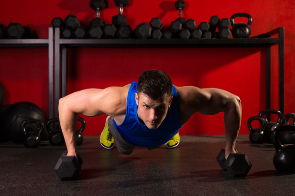 push-up strength man hex dumbbells workout at gym - Foto, Imagem
