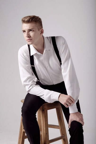 young serious man on chair, close-up portrait, fashion model - Fotó, kép