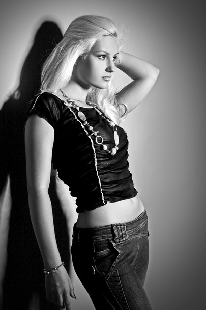 Glamorous young women in black shirt and jeans - Valokuva, kuva