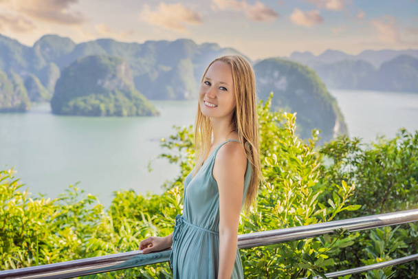 Attractive woman in a dress is traveling in Halong Bay. Vietnam. Travel to Asia, happiness emotion, summer holiday concept. Picturesque sea landscape. Ha Long Bay, Vietnam - 写真・画像