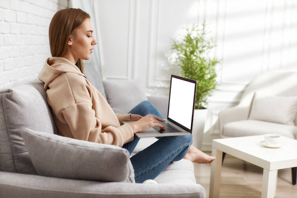 young woman using laptop at home - Fotó, kép