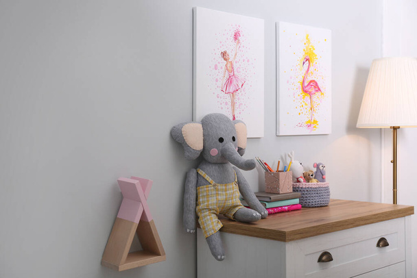 Chest of drawers and beautiful pictures in children's room. Interior design - Zdjęcie, obraz