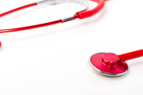 Red stethoscope on white background, close up home health care concept - Photo, image
