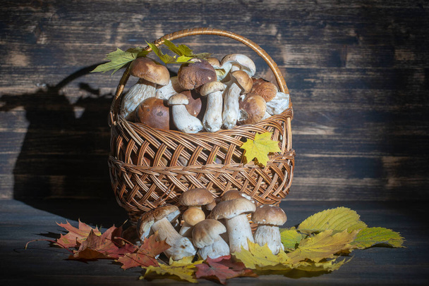 A basket of porcini mushrooms on a wooden background, close up. Ukraine - Fotografie, Obrázek