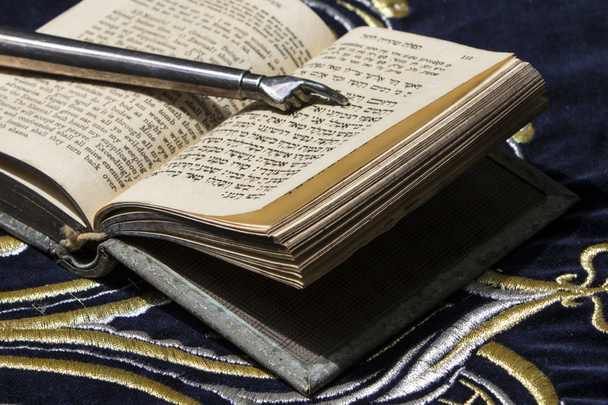 Open bible book in Hebrew with silver pointing hand stick - Photo, Image