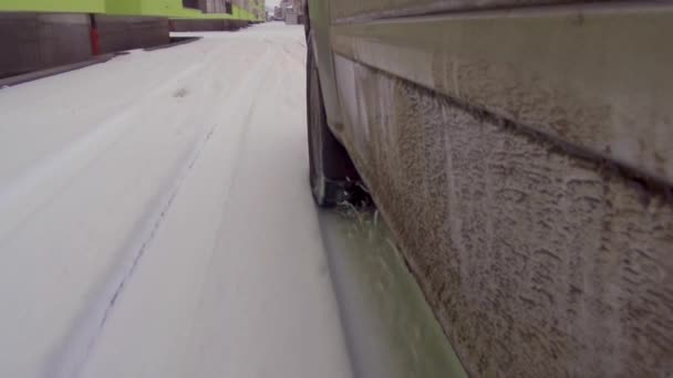 Κλείσιμο τροχού αυτοκινήτου σε δρόμο σε χειμερινή κατάσταση - Πλάνα, βίντεο