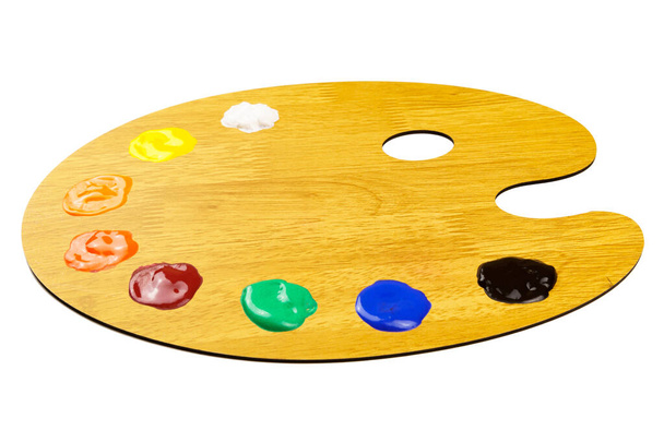 Isolated wooden palette with multi-colored paints. Artist's palette - Photo, Image