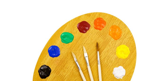 Art palette with paints and brushes isolated on white background. Artist's set - Фото, изображение