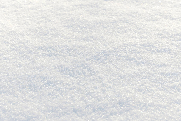 白いきれいな光沢のある雪の背景のテクスチャ。新雪のシームレスな質感。雪の表面が閉じて - 写真・画像