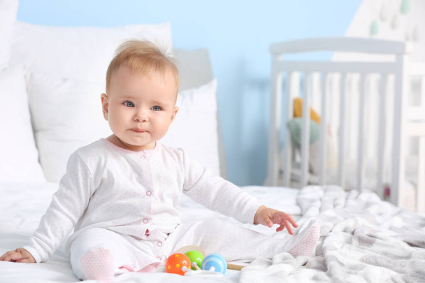 Cute little baby sitting on bed at home - Photo, Image