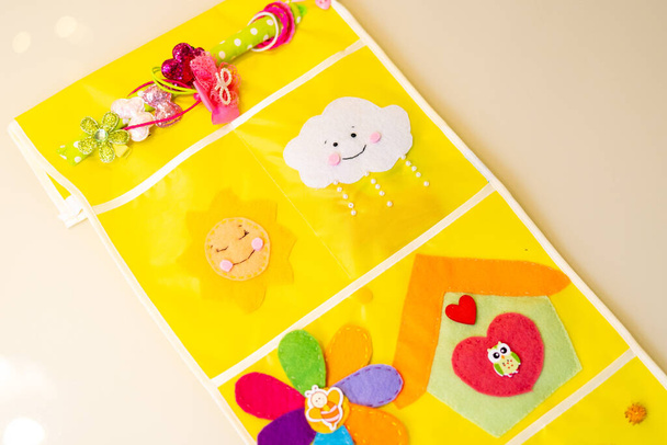 Pockets for kindergarten. Storage system in children's locker in kindergarten. Applications and decorative elements are sewn from felt. Spring or summer crafts for children and adults. - Photo, image
