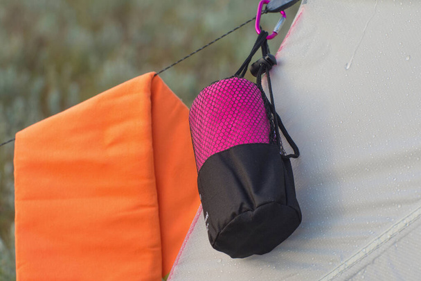 Hiking in the summer. Towel hanging on a tourist tent. Rest on a halt. - Photo, Image