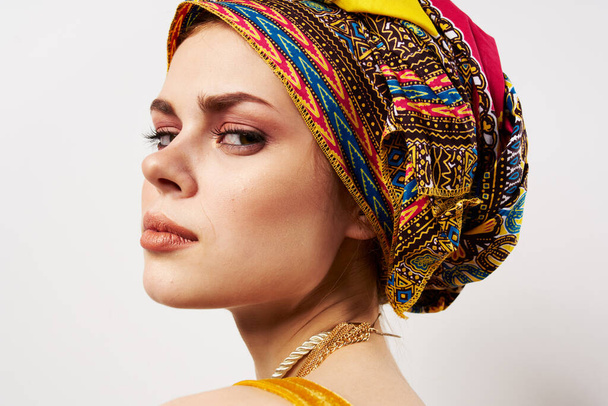 beautiful woman multicolored turban on her head decoration traditional clothing close-up - Photo, image