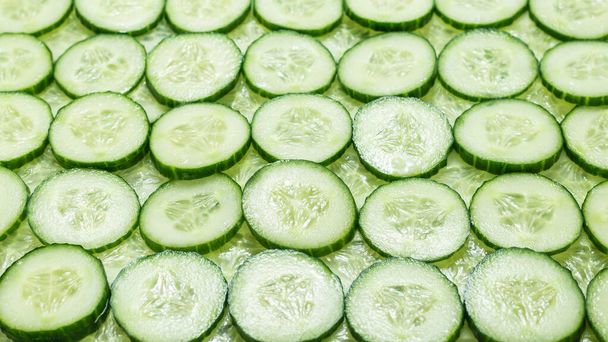 Fresh green slices of cucumber as background. Top view.  - Photo, Image