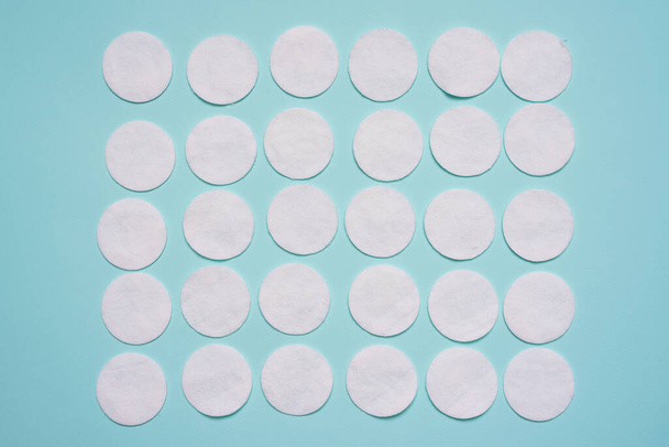 Cotton pads on the blue background. - Foto, imagen