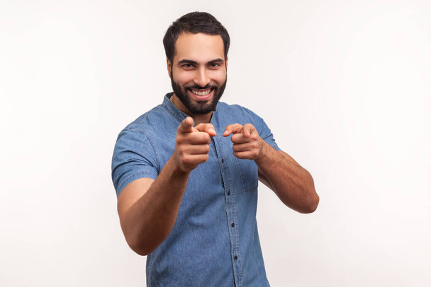 You are special! Positive happy man pointing fingers at camera and looking with toothy smile, believes in you, motivation. Indoor studio shot isolated on white background - Foto, Imagem
