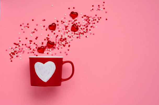 Red cup mug with with painted heart, sugar and chocolate hearts on pink background. Flat lay composition. Valentines Day concept. Top view, copy space. - Foto, immagini