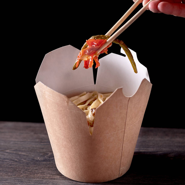 spicy sausage spaghetti in disposable container on white background - Φωτογραφία, εικόνα