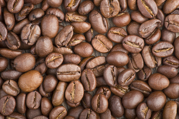 Coffee beans on wood table - Фото, зображення