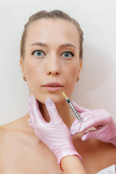 Lip augmentation procedure for a beautiful young girl. Cosmetology - Foto, Imagem