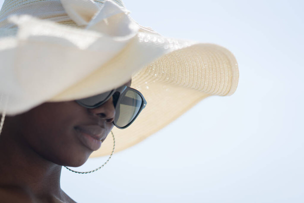 Beautiful young black African American woman on tropical beach - Fotó, kép