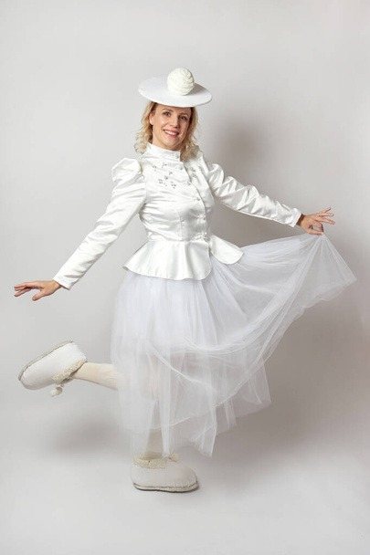 Cute young smiling woman in full height in a long skirt and jacket. Fancy dress. - Foto, Bild
