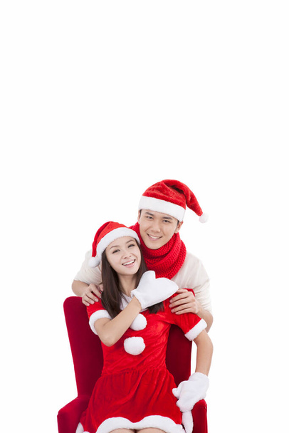 Portrait of young couple wearing Santa hats,smiling - Photo, image