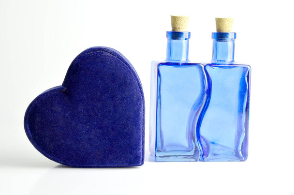 Love concept of a blue heart and two bottles - Photo, Image