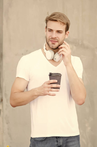 There are dozens of drinks you can pick. Handsome man drink coffee to go paper cup. Cafe concept. Coffee shop. Peaceful calm guy enjoy fresh hot brewed coffee. Perfect latte. Daily caffeine amount - Foto, Imagen