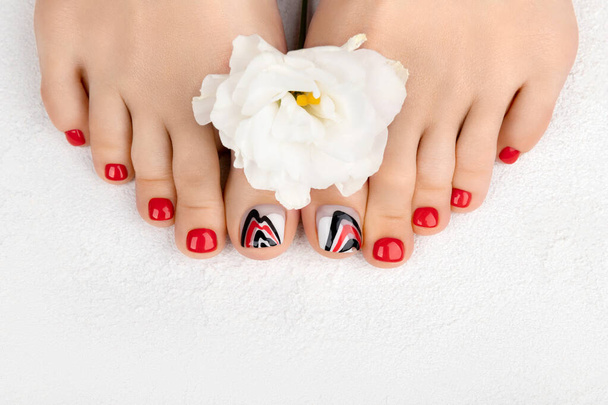 Manicure, pedicure beauty salon concept. Womans feet on gray background - Photo, Image