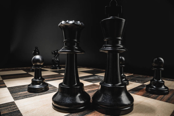 Chess board with figures on dark background - Foto, Imagen