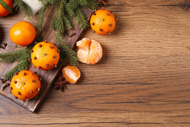 Delicious fresh tangerines and Christmas decor on wooden table, flat lay. Space for text - Photo, image